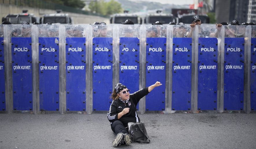 Riot police hold their shields as a supporter of Turkey's main opposition Republican People's Party (CHP) shouts slogans during a demonstration outside the party's headquarters in Istanbul, Monday, Sept. 8, 2025. (AP Photo/Francisco Seco)