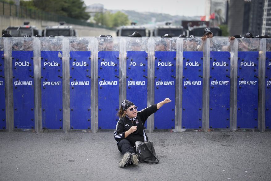 Riot police hold their shields as a supporter of Turkey's main opposition Republican People's Party (CHP) shouts slogans during a demonstration outside the party's headquarters in Istanbul, Monday, Sept. 8, 2025. (AP Photo/Francisco Seco)