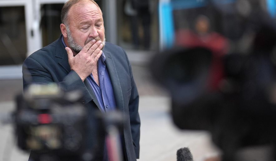 FILE - Alex Jones pauses before speaking to the media after arriving at the federal courthouse for a hearing in front of a bankruptcy judge, June 14, 2024, in Houston. (AP Photo/David J. Phillip, file)