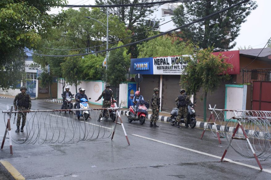 Nepalese army personnel check and question civilians at a checkpoint in Kathmandu, Nepal, Wednesday, Sept. 10, 2025. (AP Photo/Niranjan Shrestha)