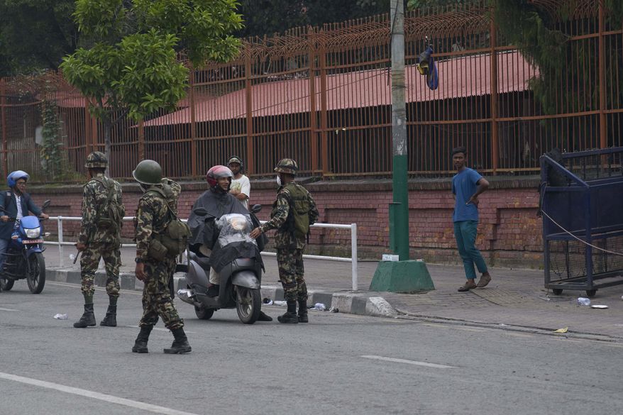 Nepalese army personnel check and question civilians at a checkpoint in Kathmandu, Nepal, Wednesday, Sept. 10, 2025. (AP Photo/Niranjan Shrestha)