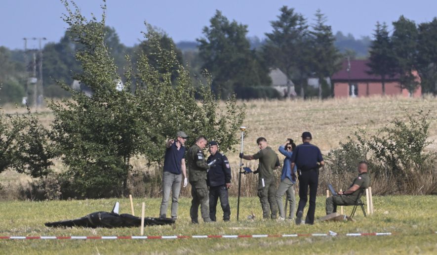 Police and Military Police secure parts of a damaged UAV shot down by Polish authorities at a site in Wohyn, Poland, Wednesday, Sept. 10, 2025.(AP Photo)