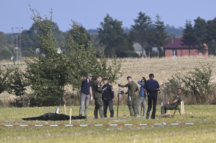 Police and Military Police secure parts of a damaged UAV shot down by Polish authorities at a site in Wohyn, Poland, Wednesday, Sept. 10, 2025.(AP Photo)