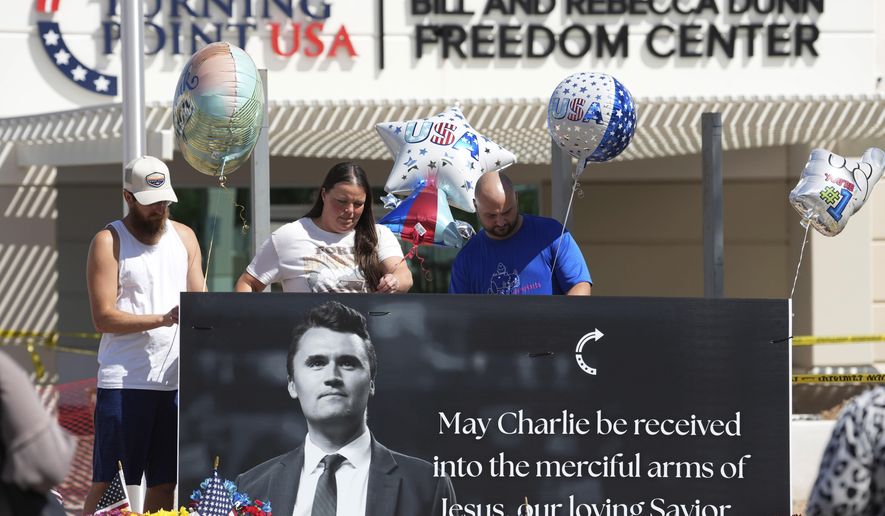 Well-wishers add balloons to a makeshift memorial set up at Turning Point USA headquarters after the shooting death at a Utah college on Wednesday of Charlie Kirk, the 31-year-old founder and CEO of the organization, Thursday, Sept. 11, 2025, in Phoenix. (AP Photo/Ross D. Franklin)