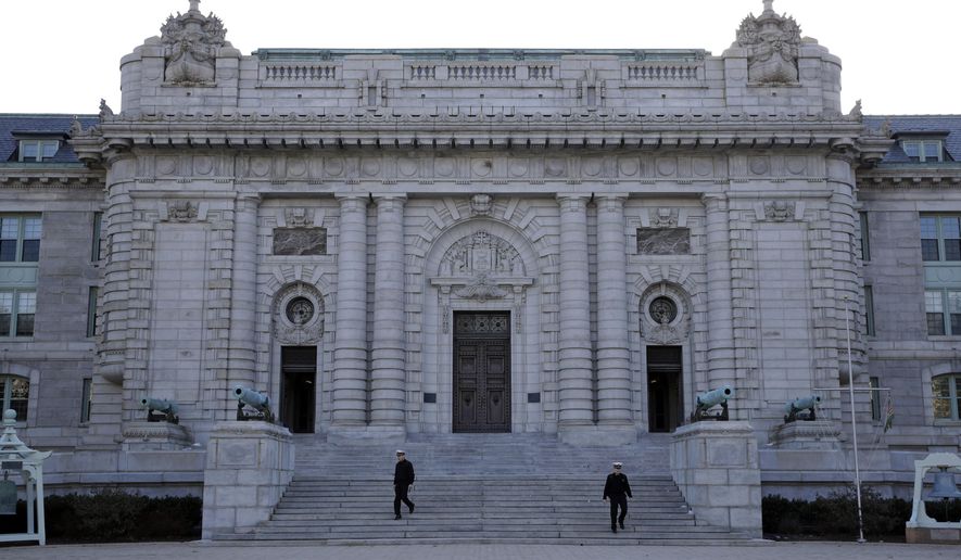 FILE - Midshipmen walk down the front steps of Bancroft Hall, the main dormitory on the U.S. Naval Academy campus in Annapolis, Md., Jan. 9, 2014. (AP Photo/Patrick Semansky, File)