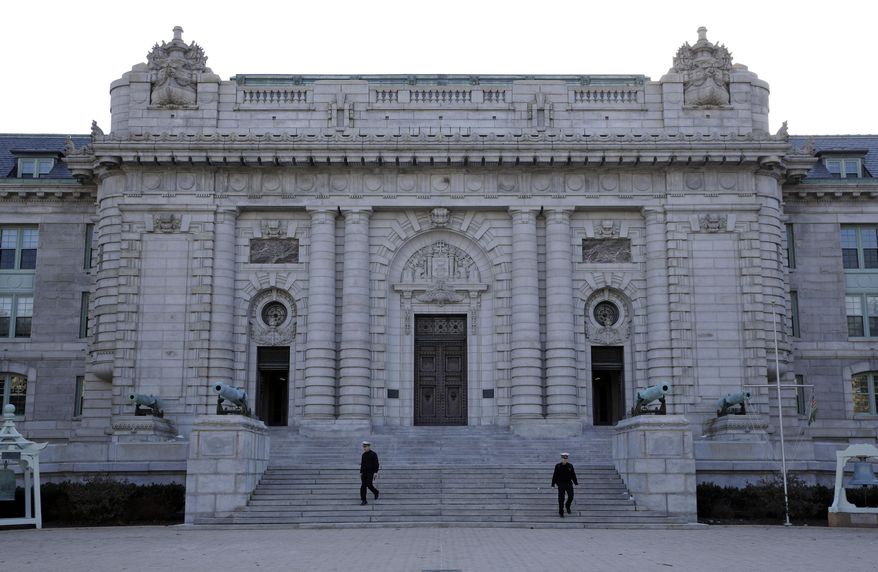 FILE - Midshipmen walk down the front steps of Bancroft Hall, the main dormitory on the U.S. Naval Academy campus in Annapolis, Md., Jan. 9, 2014. (AP Photo/Patrick Semansky, File)