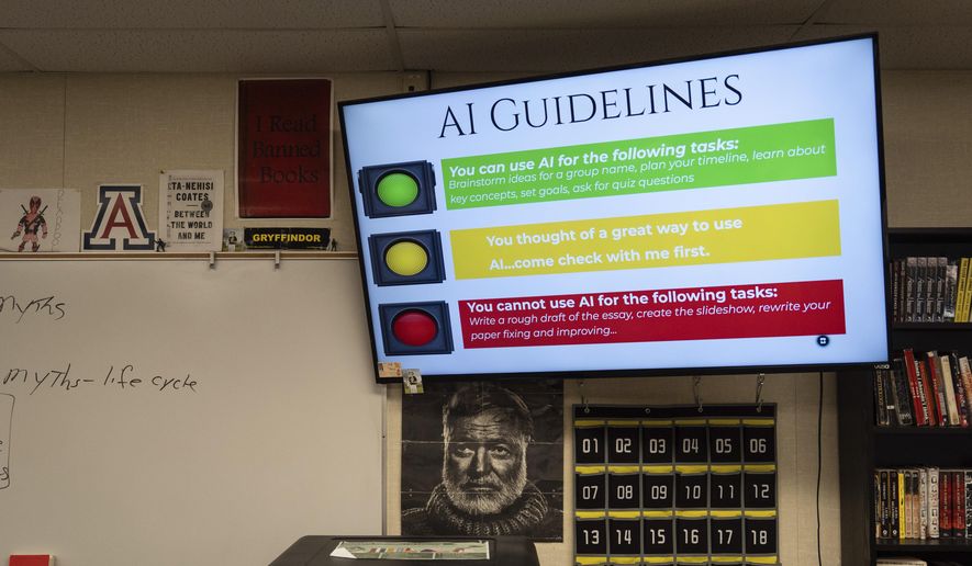 A screen displays guidelines for using artificial intelligence above a portrait of Ernest Hemingway in Casey Cuny's English class at Valencia High School in Santa Clarita, Calif., Wednesday, Aug. 27, 2025. (AP Photo/Jae C. Hong) ** FILE **