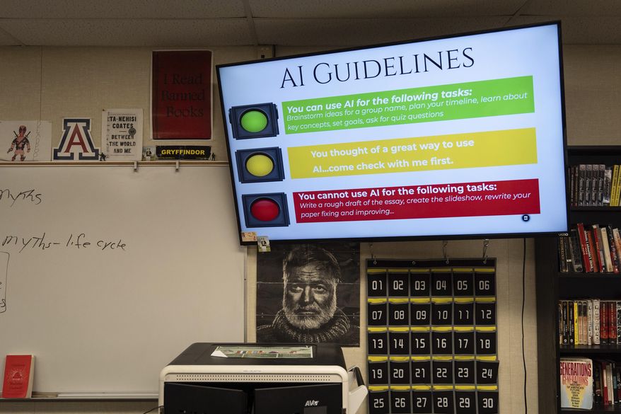 A screen displays guidelines for using artificial intelligence above a portrait of Ernest Hemingway in Casey Cuny's English class at Valencia High School in Santa Clarita, Calif., Wednesday, Aug. 27, 2025. (AP Photo/Jae C. Hong) ** FILE **