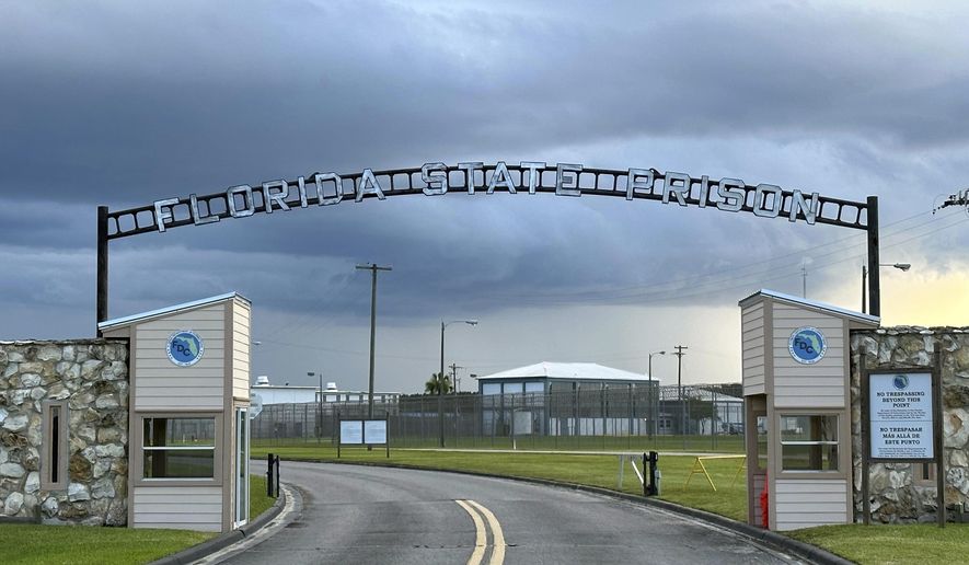FILE - Clouds hover over the entrance of the Florida State Prison in Starke, Fla., Aug. 3, 2023. (AP Photo/Curt Anderson, file)