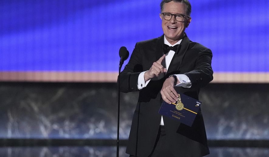 Stephen Colbert presents the award for outstanding lead actor in a comedy series during the 77th Primetime Emmy Awards on Sunday, Sept. 14, 2025, at the Peacock Theater in Los Angeles. (AP Photo/Chris Pizzello)