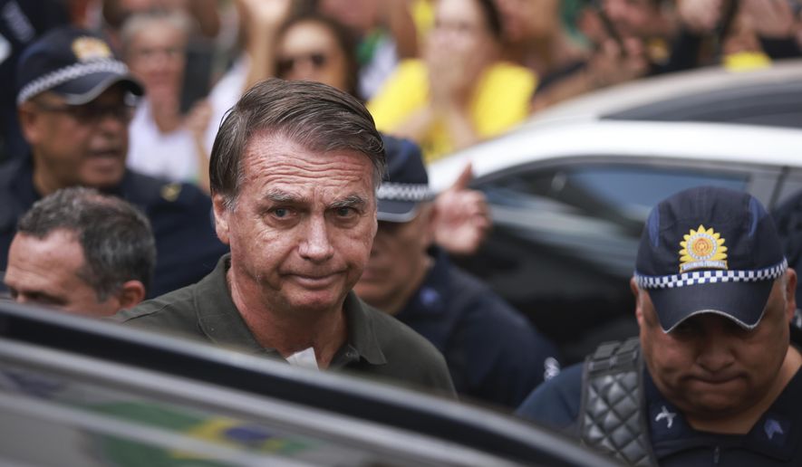Former President Jair Bolsonaro, temporarily allowed out of house arrest for medical treatment, departs a hospital in Brasilia, Brazil, Sunday, Sep. 14, 2025. (AP Photo/Luis Nova) ** FILE **