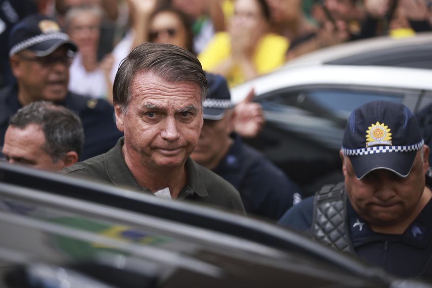 Former President Jair Bolsonaro, temporarily allowed out of house arrest for medical treatment, departs a hospital in Brasilia, Brazil, Sunday, Sep. 14, 2025. (AP Photo/Luis Nova) ** FILE **