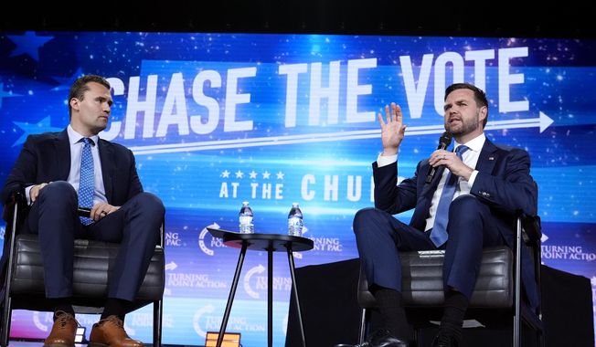 FILE - Republican vice presidential nominee Sen. JD Vance, R-Ohio, right, speaks at a campaign event as Turning Point USA Founder Charlie Kirk, left, listens, Wednesday, Sept. 4, 2024, in Mesa, Ariz. (AP Photo/Ross D. Franklin, File)