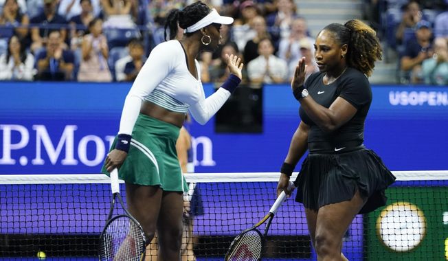 Serena Williams, right, and Venus Williams celebrate during their first-round doubles match against Lucie Hradecká and Linda Nosková, of the Czech Republic, at the U.S. Open tennis championships, Sept. 1, 2022, in New York. (AP Photo/Frank Franklin II, file)