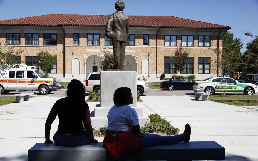 FILE - Students sit on a bench in front of Kent Wyatt Hall on Delta State University's Cleveland, Miss., campus on Sept. 14, 2015. (AP Photo/Rogelio V. Solis, File)