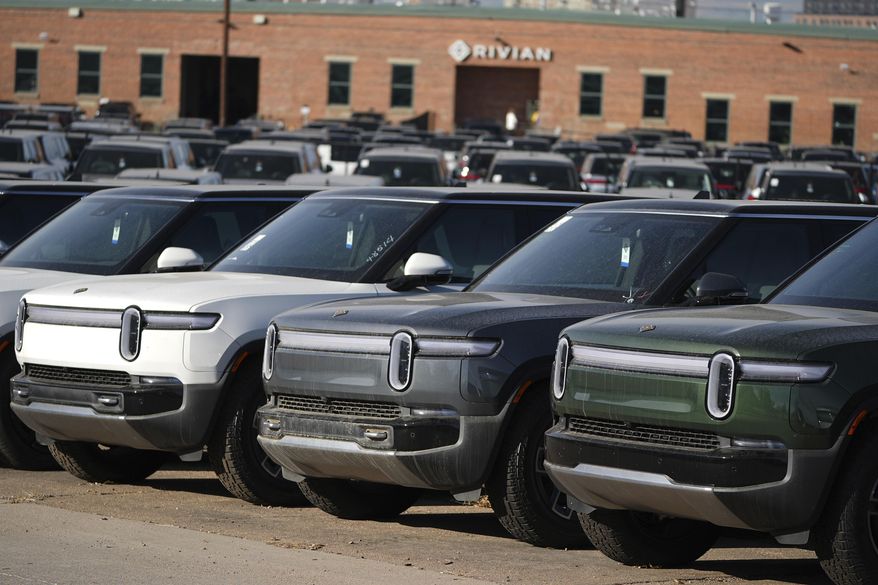 A long line of unsold 2024 R1S electric utility vehicles sits at a Rivian service center in east Denver on Nov. 26, 2024. (AP Photo/David Zalubowski) **FILE**