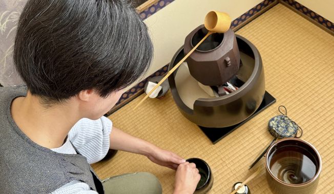 Anri Frank, practices making matcha during a traditional Japanese tea service class, Monday, Sept. 8, 2025, in San Francisco. (AP Photo/Haven Daley)