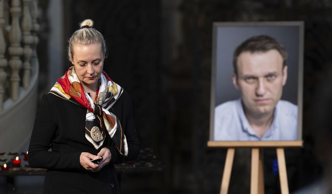 Yulia Navalnaya, widow of Russian opposition leader Alexei Navalny walks away from his picture after lighting a candle at the end of a service in St. Mary's Church on the occasion of his birthday, in Berlin, June 4, 2024. (Christoph Gollnow/dpa/dpa via AP, File)