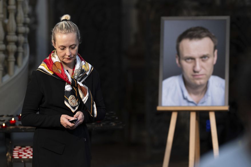 Yulia Navalnaya, widow of Russian opposition leader Alexei Navalny walks away from his picture after lighting a candle at the end of a service in St. Mary's Church on the occasion of his birthday, in Berlin, June 4, 2024. (Christoph Gollnow/dpa/dpa via AP, File)