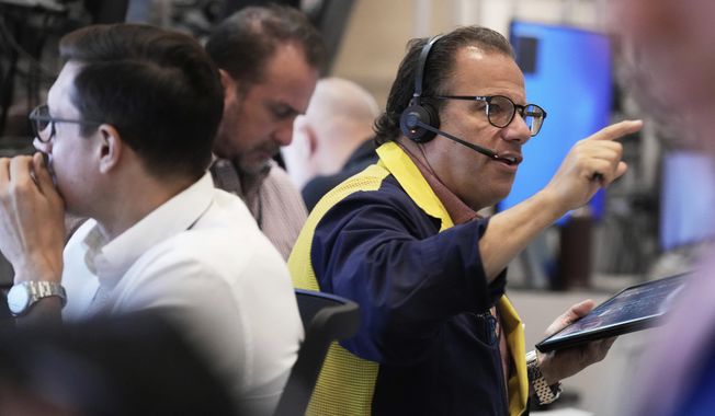 Options trader Anthony Spina, right, works on the floor of the New York Stock Exchange, Monday, Sept. 15, 2025. (AP Photo/Richard Drew)