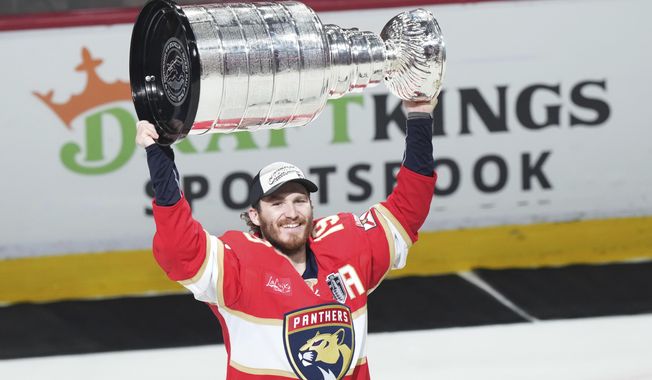 Florida Panthers' Matthew Tkachuk (19) raises the Stanley Cup after defeating the Edmonton Oilers in Game 6 of the NHL hockey Stanley Cup Final in Sunrise, Fla., Tuesday, June 17, 2025. (Nathan Denette/The Canadian Press via AP)