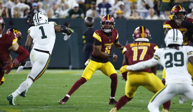 Washington Commanders quarterback Jayden Daniels (5) throws toward wide receiver Terry McLaurin (17) as Green Bay Packers defensive lineman Micah Parsons (1) defends during the first half of an NFL football game Thursday, Sept. 11, 2025, in Green Bay, Wis. (AP Photo/Mike Roemer) ** FILE **