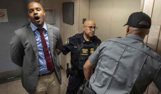 New York State Senator Jabari Brisport chants while detained by federal agents after demanding access to inspect the detainment facility at immigration court at the Jacob K. Javits federal building, Thursday, Sept. 18, 2025, in New York. (AP Photo/Yuki Iwamura)