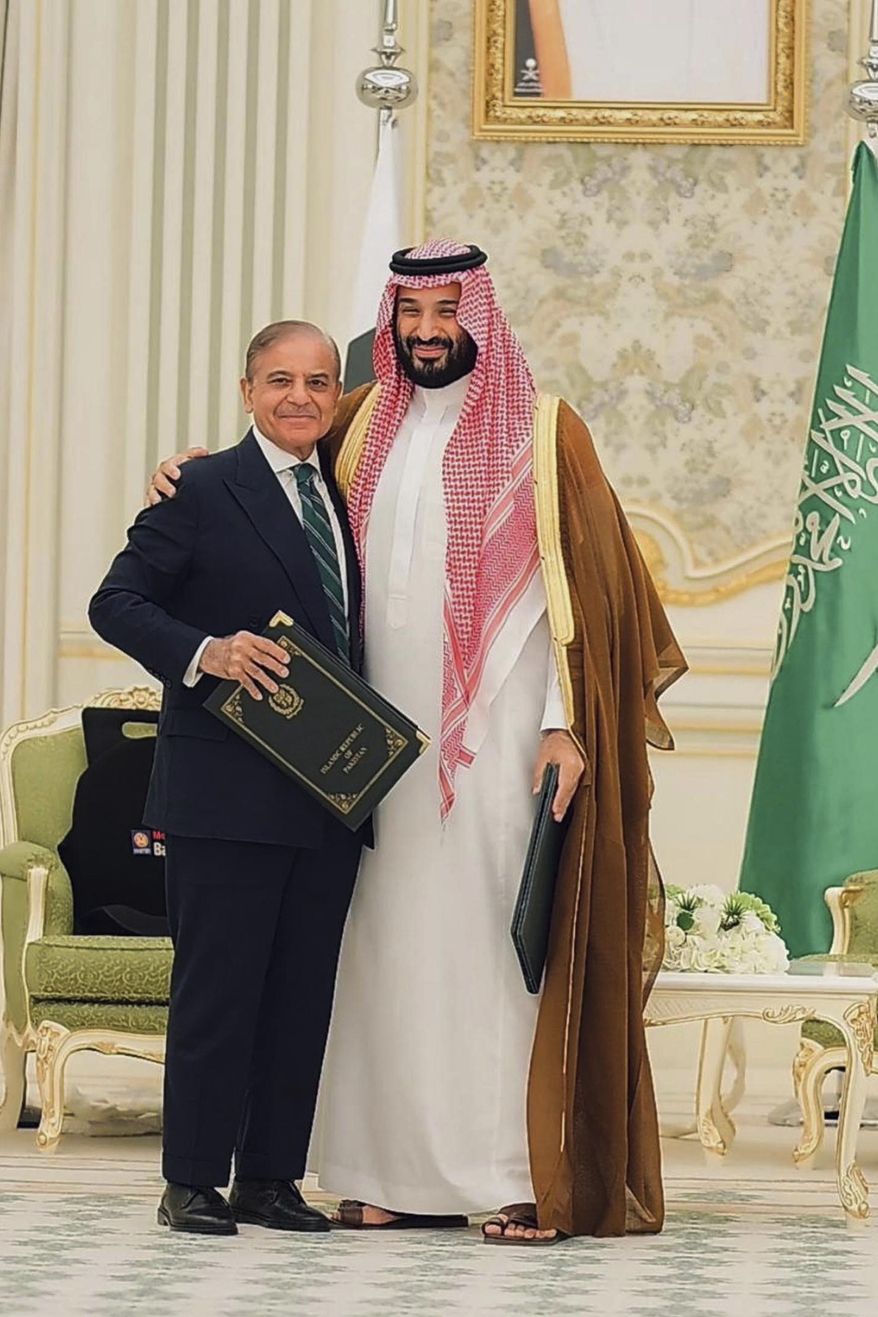 In this photo released by Pakistan's Press Information Department, Saudi Arabia's Crown Prince Mohammed bin Salman, right, and Pakistan's Prime Minister Shehbaz Sharif pose for photograph after signing a mutual defense pact, in Riyadh, Saudi Arabia, Wednesday, Sept. 17, 2025. (Press Information Department via AP) ** FILE **