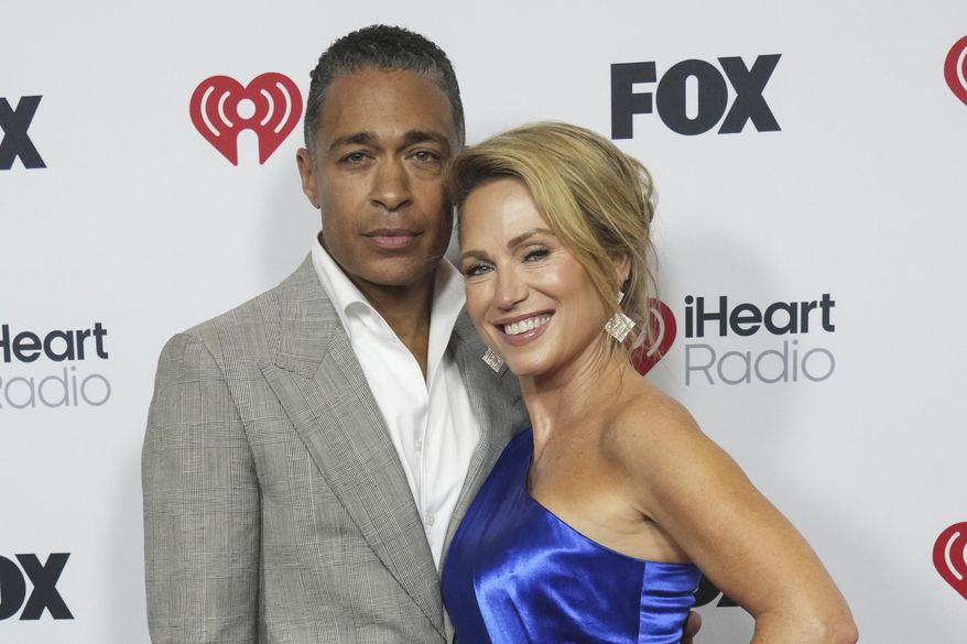 T. J. Holmes, left, and Amy Robach appear at the iHeartRadio Music Awards in Los Angeles on March 17, 2025. (Photo by Jordan Strauss/Invision/AP, File)