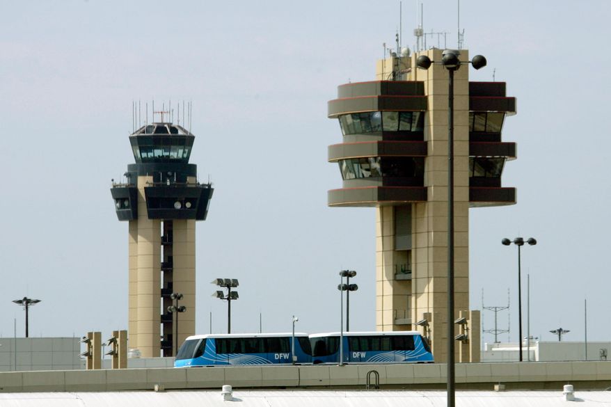 A Skylink tram passes in front of control towers at the Dallas-Fort Worth International Airport in Grapevine, Texas, on Sunday, Aug. 10, 2008. (AP Photo/Matt Slocum, File)