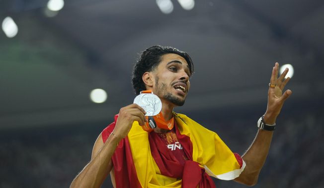 FILE - Mohamed Katir, of Spain celebrates with his silver medal in the final of the Men's 5000-meters during the World Athletics Championships in Budapest, Hungary, on Aug. 27, 2023. (AP Photo/Petr David Josek, File)