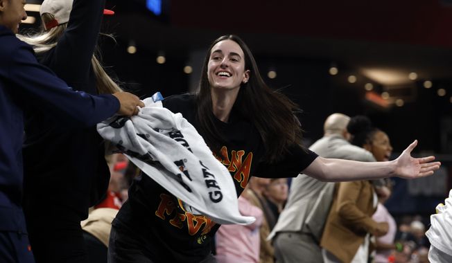 Indiana Fever guard Caitlin Clark, center, reacts after a score to take the lead over the Atlanta Dream during the second half of Game 3 in the first round of the WNBA basketball playoffs, Thursday, Sept. 18, 2025, in Atlanta. (AP Photo/Butch Dill)