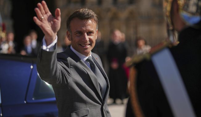 FILE - French President Emmanuel Macron waves after visiting Notre Dame cathedral with King Frederik X of Denmark and Queen Mary of Denmark, Wednesday, April 2, 2025 in Paris. (AP Photo/Thibault Camus, File)