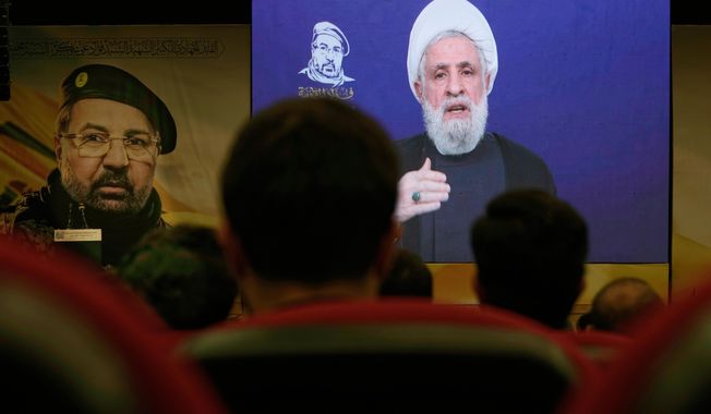 FILE - People listen in Dahiyeh, a southern suburb of Beirut, Lebanon, as Hezbollah leader Naim Kassem delivers a televised speech Wednesday, July 30, 2025, during a commemoration marking the first anniversary of the death of top Hezbollah commander Fouad Shukur, who was killed in an Israeli airstrike. (AP Photo/Bilal Hussei, File)