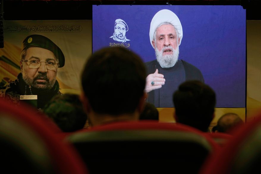 FILE - People listen in Dahiyeh, a southern suburb of Beirut, Lebanon, as Hezbollah leader Naim Kassem delivers a televised speech Wednesday, July 30, 2025, during a commemoration marking the first anniversary of the death of top Hezbollah commander Fouad Shukur, who was killed in an Israeli airstrike. (AP Photo/Bilal Hussei, File)