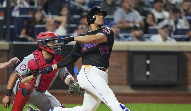 Washington Nationals catcher Jorge Alfaro, left, watches as New York Mets' Juan Soto hits a three-run home run during the fourth inning of a baseball game Friday, Sept. 19, 2025, in New York. (AP Photo/Frank Franklin II)