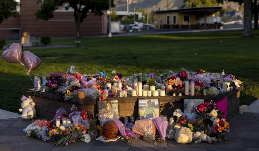 Pictures, flowers and candles mark a makeshift memorial, June 3, 2025, in Wenatchee, Wash., in honor of Olivia, Paityn and Evelyn Decker, who were found dead near Leavenworth after their father Travis Decker failed to return them after a scheduled visitation. (Nick Wagner/The Seattle Times via AP) ** FILE **