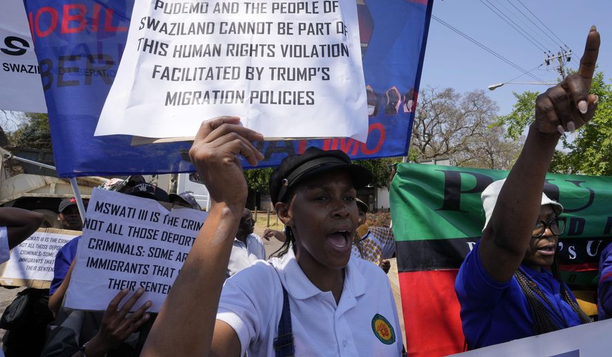 Members of Eswatin Pro-democracy activists, hold placards during their protest outside the U.S. Embassy in Pretoria, South Africa, Friday, Sept. 19, 2025. (AP Photo/Themba Hadebe)