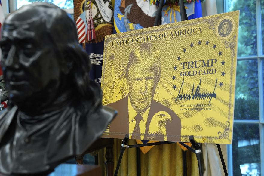 A poster showing the Trump Gold Card is pictured as President Donald Trump speaks in the Oval Office of the White House, Friday, Sept. 19, 2025, in Washington. (AP Photo/Alex Brandon)