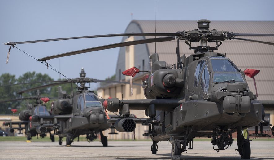 U.S. Army AH-64E Apache helicopters are pictured at Joint Base Andrews, Md., June 12, 2025. (AP Photo/Mark Schiefelbein, File)