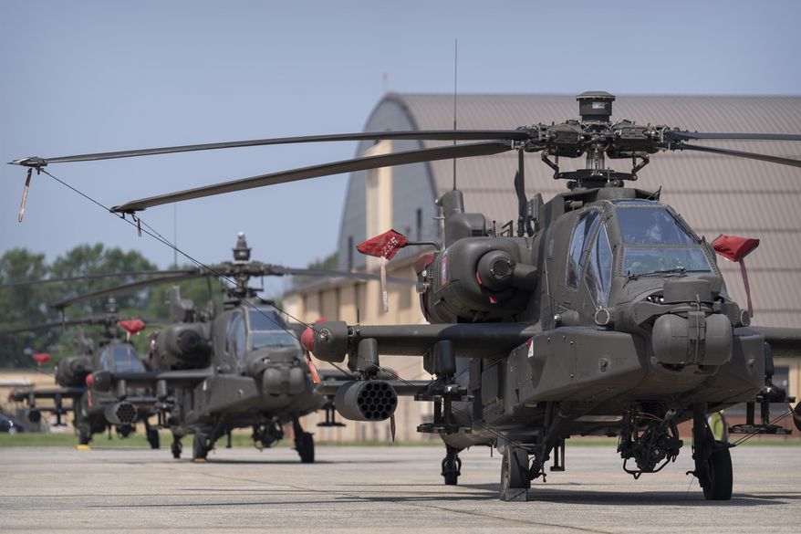 U.S. Army AH-64E Apache helicopters are pictured at Joint Base Andrews, Md., June 12, 2025. (AP Photo/Mark Schiefelbein, File)