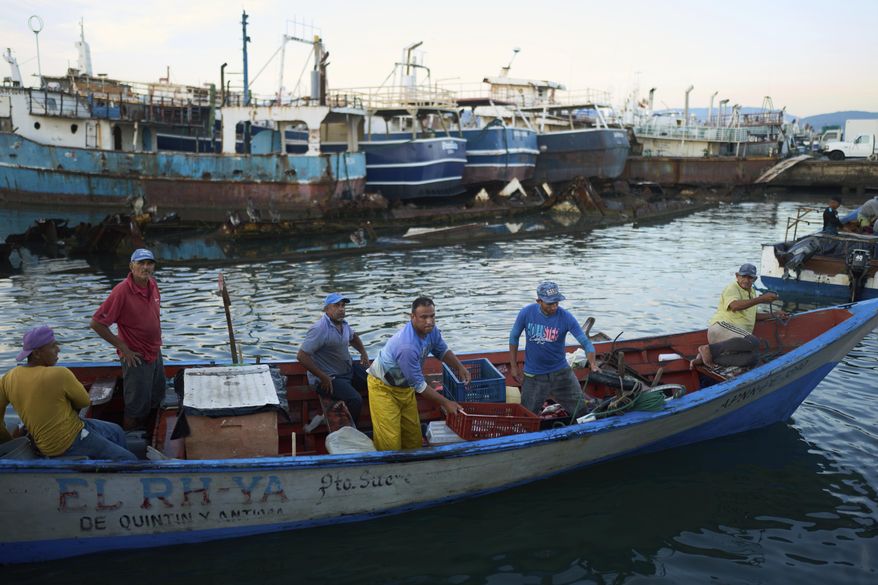 Fishermen arrive at the port in Cumana, capital of Venezuela's Sucre state, Monday, Sept. 15, 2025. (AP Photo/Ariana Cubillos)