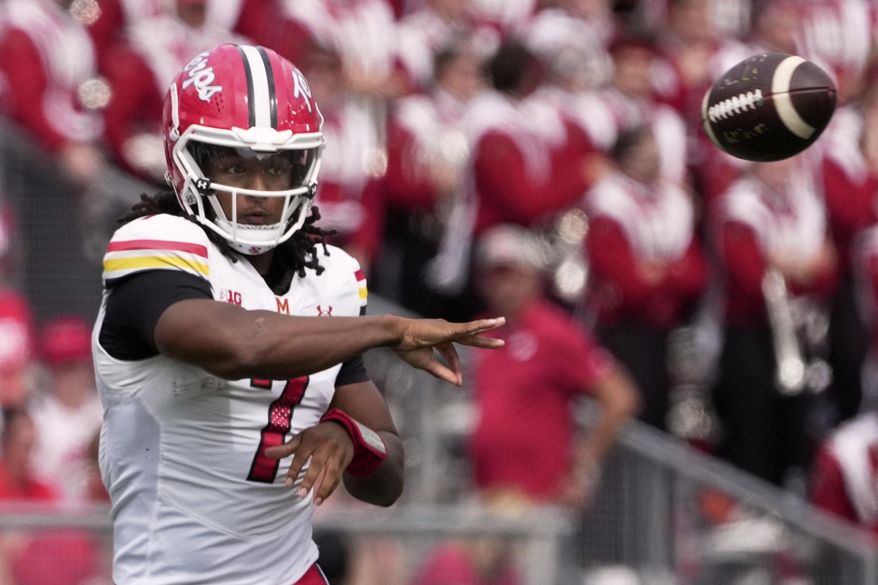 Maryland quarterback Malik Washington throws during the first half of an NCAA college football game against Wisconsin Saturday, Sept. 20, 2025, in Madison, Wis. (AP Photo/Morry Gash)