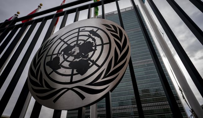 The symbol of the United Nations is displayed on the main gate outside U.N. headquarters, Feb. 24, 2022, in New York. (AP Photo/John Minchillo, File)
