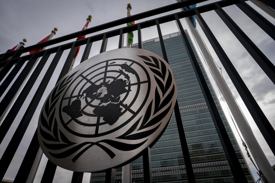 The symbol of the United Nations is displayed on the main gate outside UN headquarters, Feb. 24, 2022, in New York. (AP Photo/John Minchillo, file)