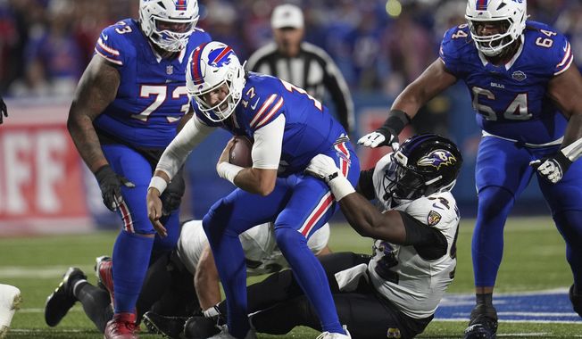 Buffalo Bills quarterback Josh Allen (17) is tackled by Baltimore Ravens defensive tackle Nnamdi Madubuike (92) during the first half of an NFL football game in Orchard Park, N.Y., Sunday, Sept. 7, 2025. (AP Photo/Gene J. Puskar)