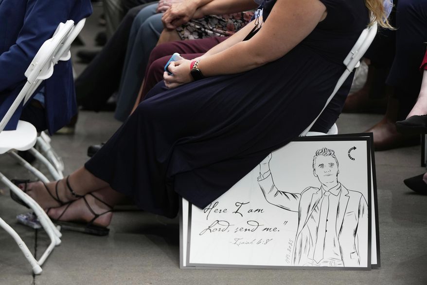A poster depicting conservative activist Charlie Kirk is pictured as people attend Kirk's memorial, Sunday, Sept. 21, 2025, at State Farm Stadium in Glendale, Ariz. (AP Photo/Julia Demaree Nikhinson)