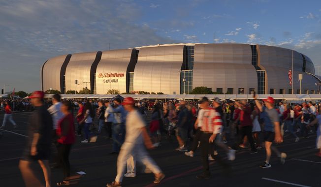 People wait in line before a memorial for conservative activist Charlie Kirk Sunday, Sept. 21, 2025, at State Farm Stadium in Glendale, Ariz. (AP Photo/Jae C. Hong)