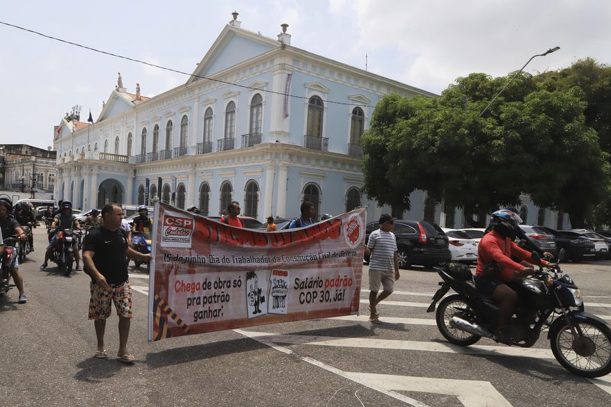 Construction workers building infrastructure for the upcoming COP30 U.N. Climate Summit protest for better pay and working conditions in Belem, Brazil, Sept.18, 2025. (AP Photo/Paulo Santos)