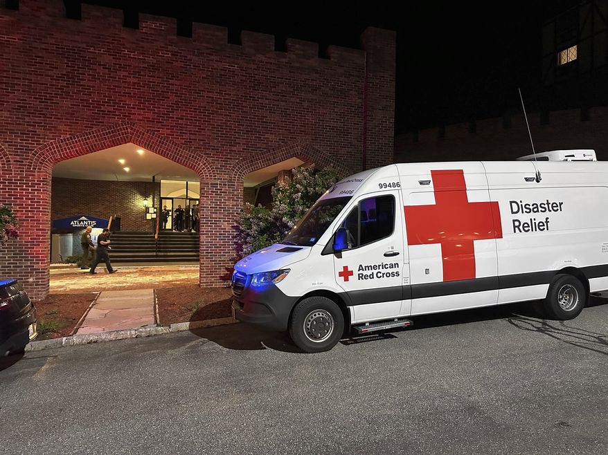 An American Red Cross Disaster Relief van is parked outside a hotel that is acting as a reunification center after a shooting at a country club in Nashua, New Hampshire, Saturday, Sept. 20, 2025. (AP Photo/Michael Casey)